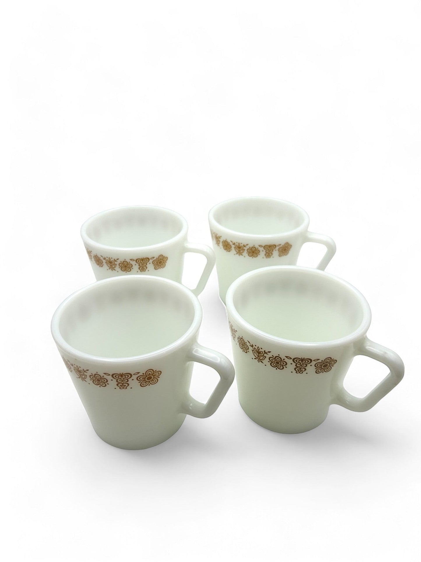 Hinson Vintage Interiors set of four white glass Pyrex coffee cups featuring a 1970s butterfly gold floral pattern.