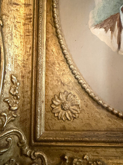 Hinson Vintage Interiors antique oval portrait painting featuring an ornate gold frame with floral and scroll motifs.