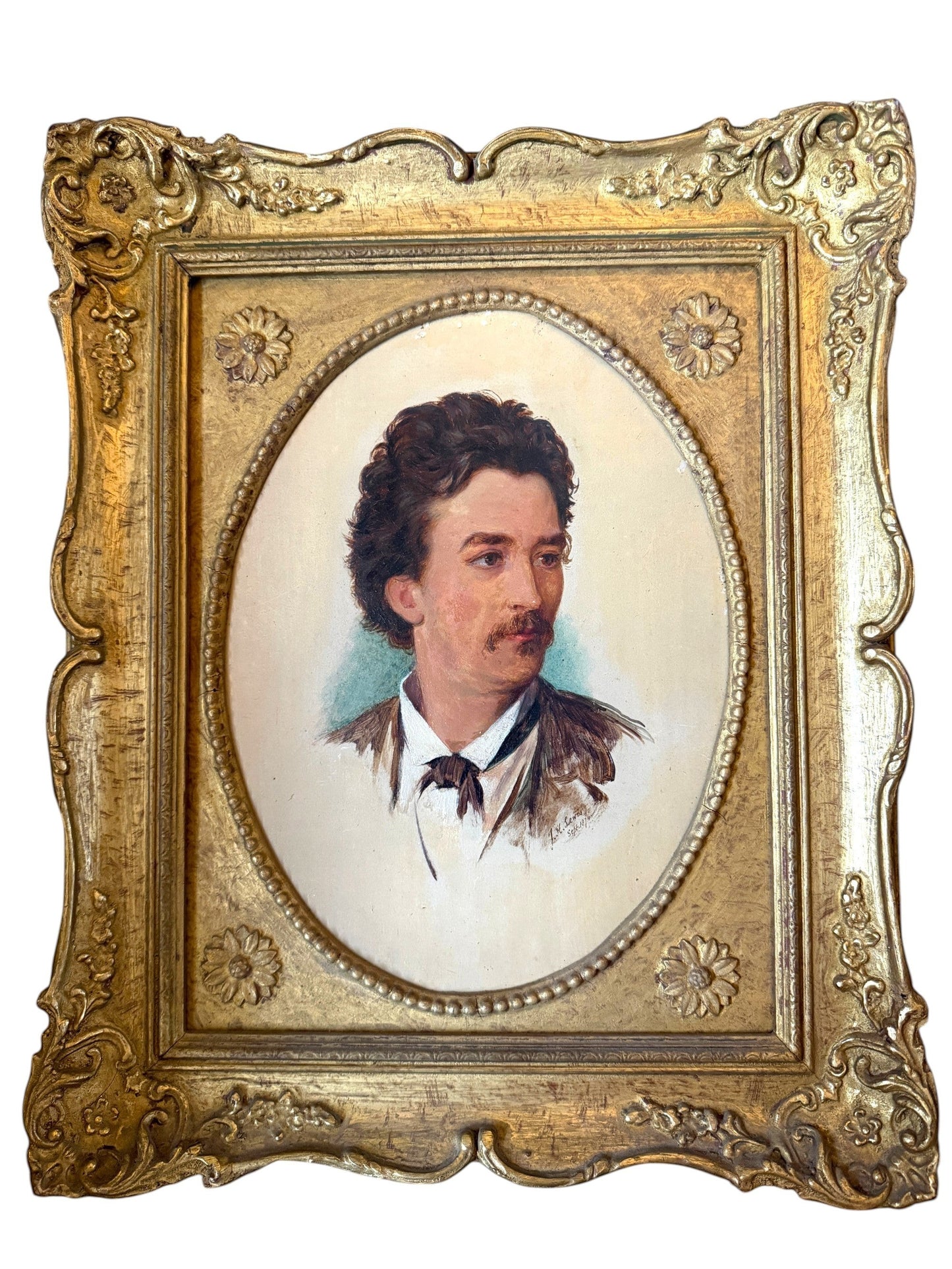 Hinson Vintage Interiors antique oval portrait of a gentleman in an ornate gold-toned floral frame from 1874.