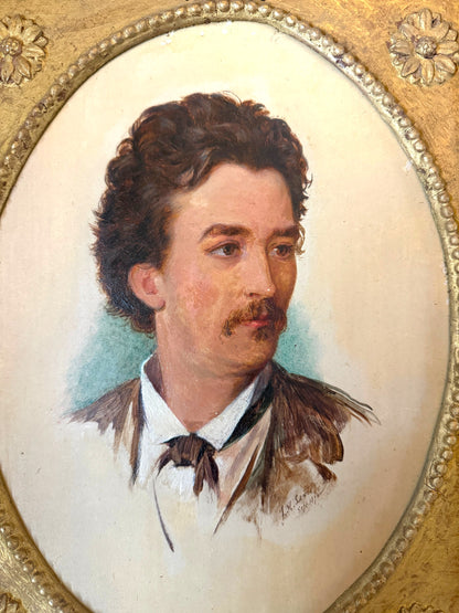 Hinson Vintage Interiors antique oval portrait of a gentleman in an ornate gold-toned floral frame, dated 1874.