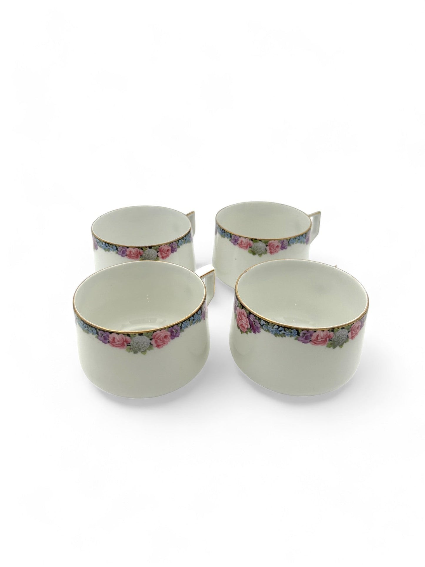 Hinson Vintage Interiors set of four white porcelain Bavarian tea cups with floral patterns and gold trim.