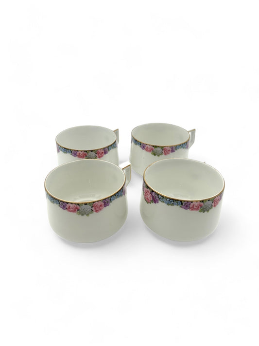 Hinson Vintage Interiors set of four white porcelain Bavarian tea cups with floral patterns and gold trim.