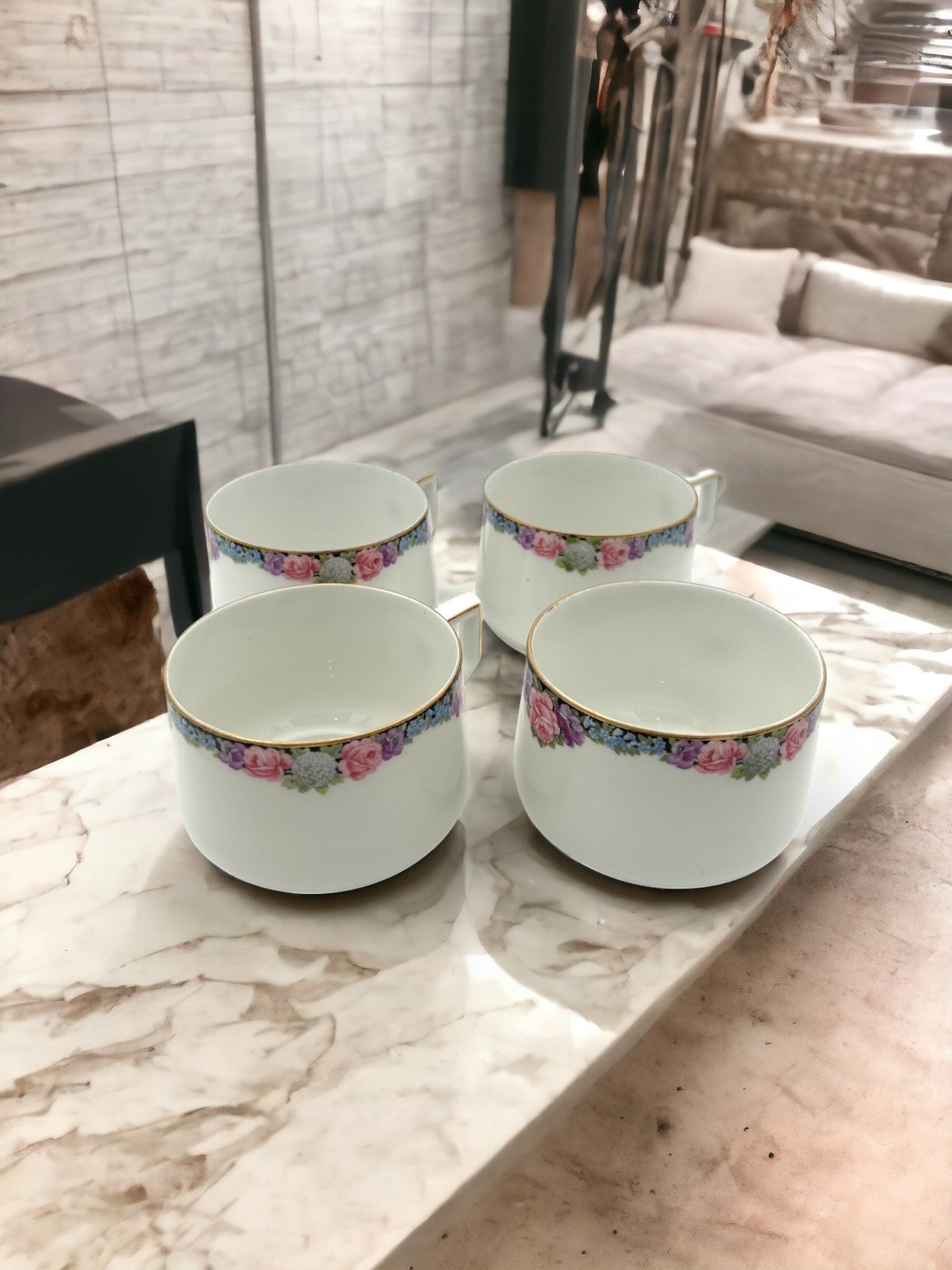 Hinson Vintage Interiors set of four white porcelain tea cups with floral patterns and gold trim from Bavaria