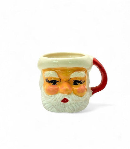 Hinson Vintage Interiors hand-painted ceramic Santa Claus mug with rosy cheeks and a festive red handle.