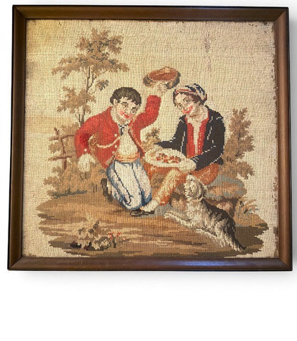 Hinson Vintage Interiors framed needlepoint art featuring a romantic courting scene with a dog in a wooden frame.