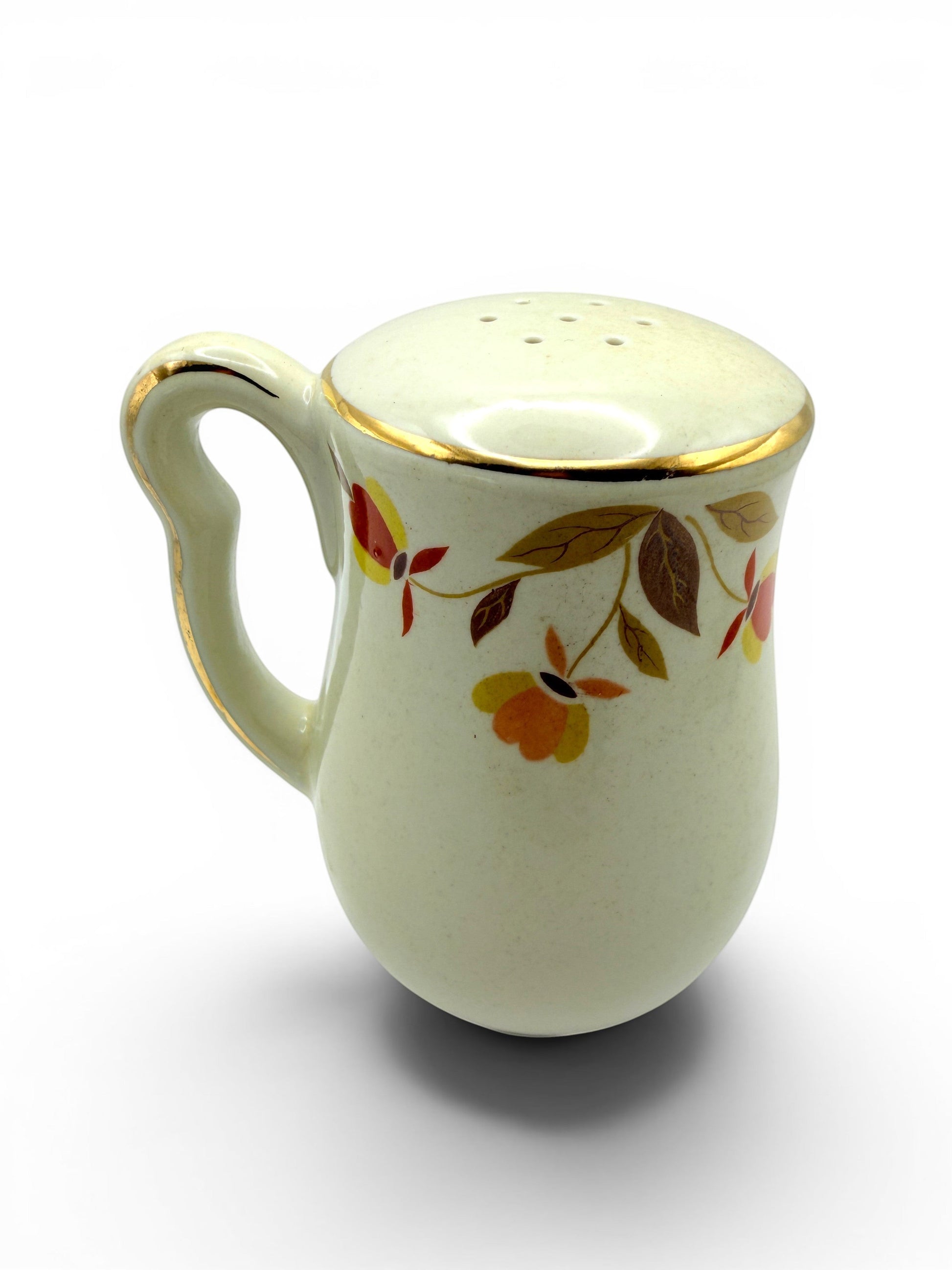 Hinson Vintage Interiors Hall China Autumn Leaf ceramic salt and pepper shaker with gold trim and floral pattern.