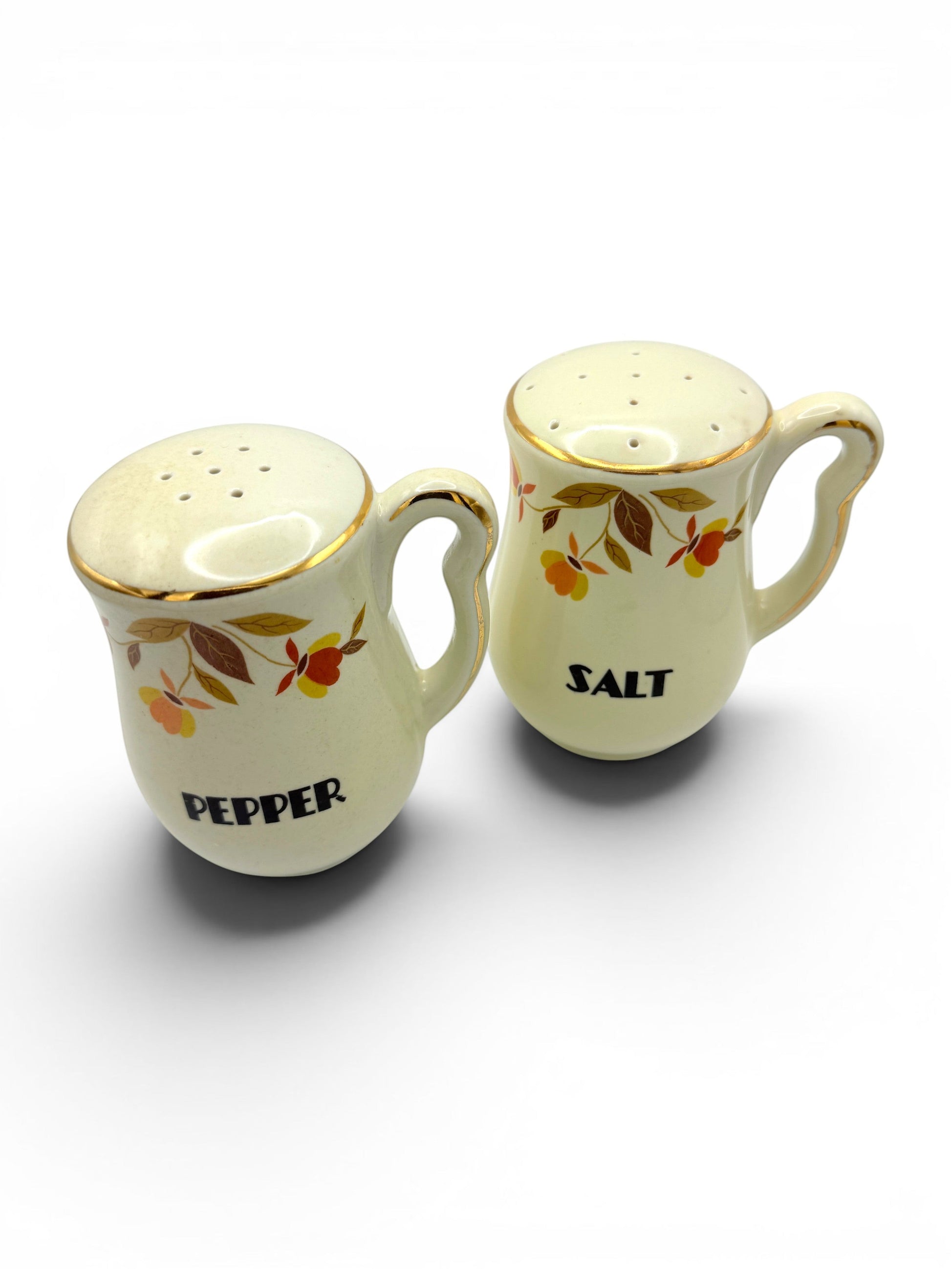 Hinson Vintage Interiors Hall China Autumn Leaf ceramic salt and pepper shakers with gold trim and floral pattern.
