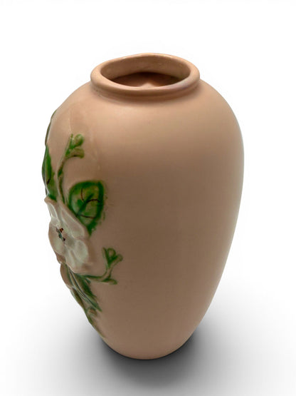 Hinson Vintage Interiors blush pink Hull Pottery vase with raised white floral and green leaf relief detail.