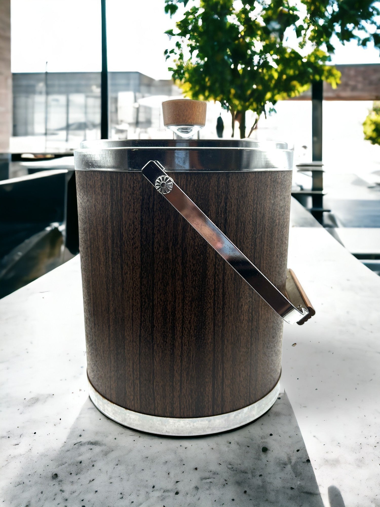 Hinson Vintage Interiors mid-century Kromex ice bucket with faux wood finish, chrome accents, and a sturdy handle.