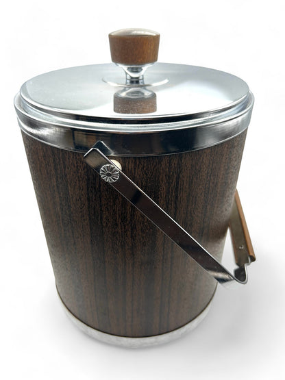 Hinson Vintage Interiors mid-century Kromex ice bucket with faux wood finish, chrome lid, and handle.