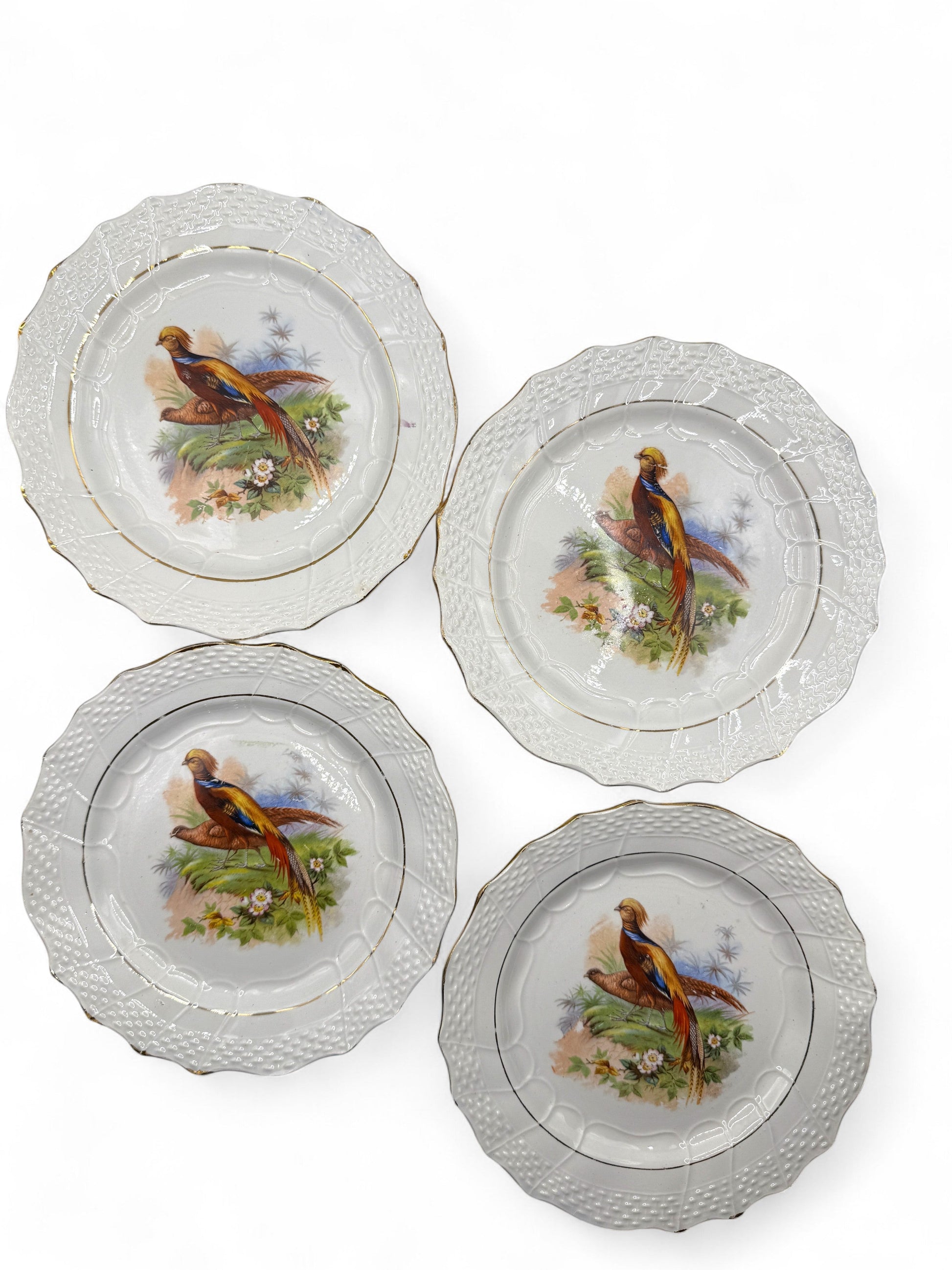 Hinson Vintage Interiors set of four antique Moulin des Loups French faience dessert plates with game bird motifs.