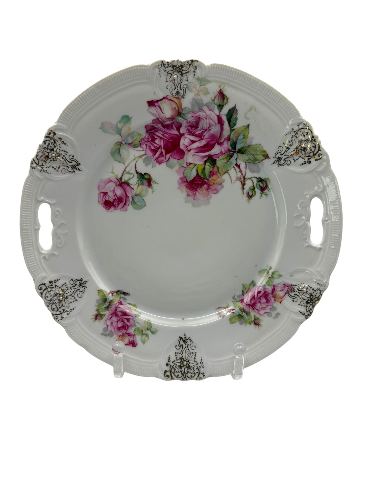 Hinson Vintage Interiors porcelain cake plate with pink roses, green leaves, and black-and-gold scroll accents.