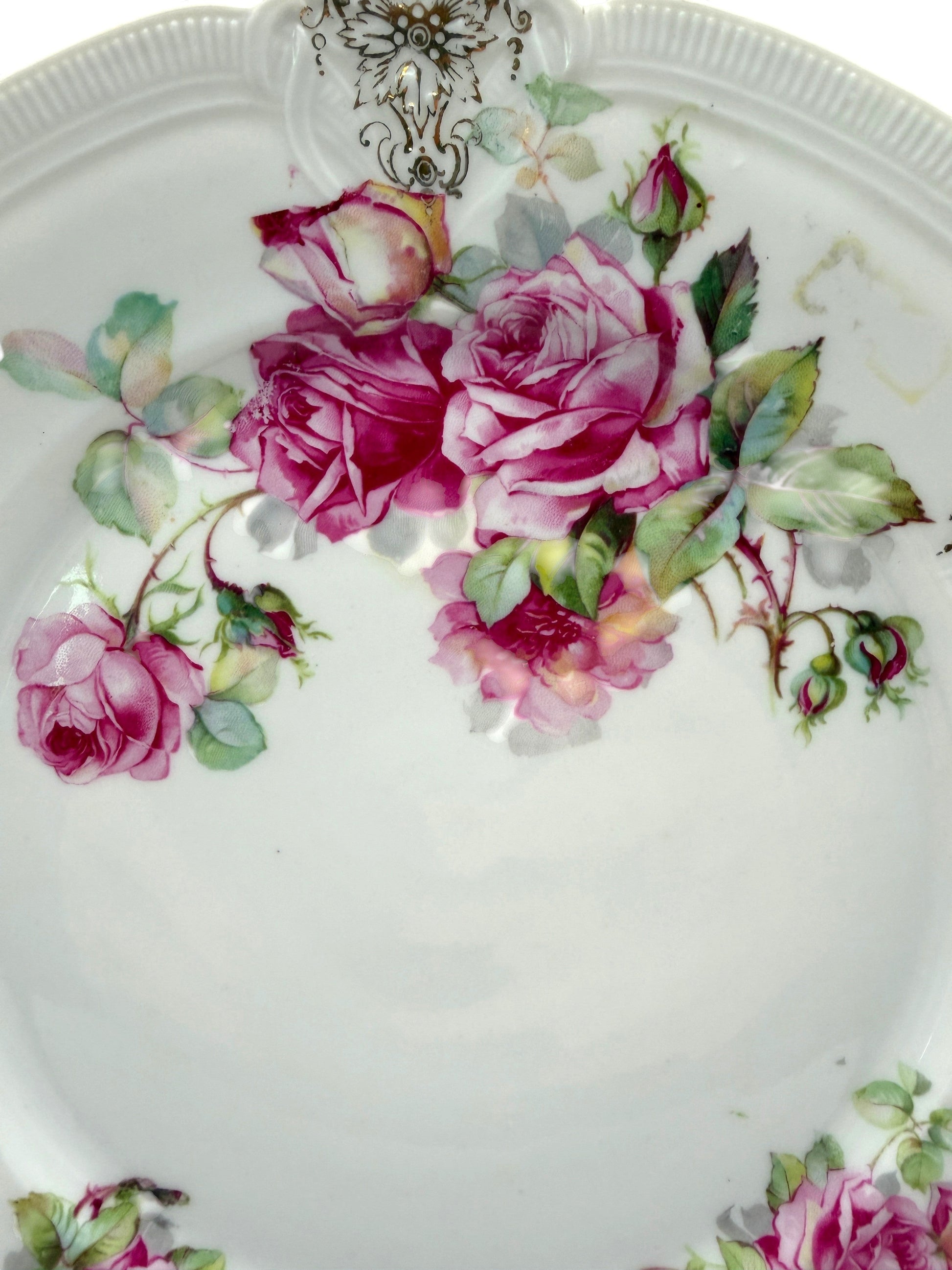 Hinson Vintage Interiors porcelain cake plate with pink roses, green leaves, and black and gold scroll detailing.
