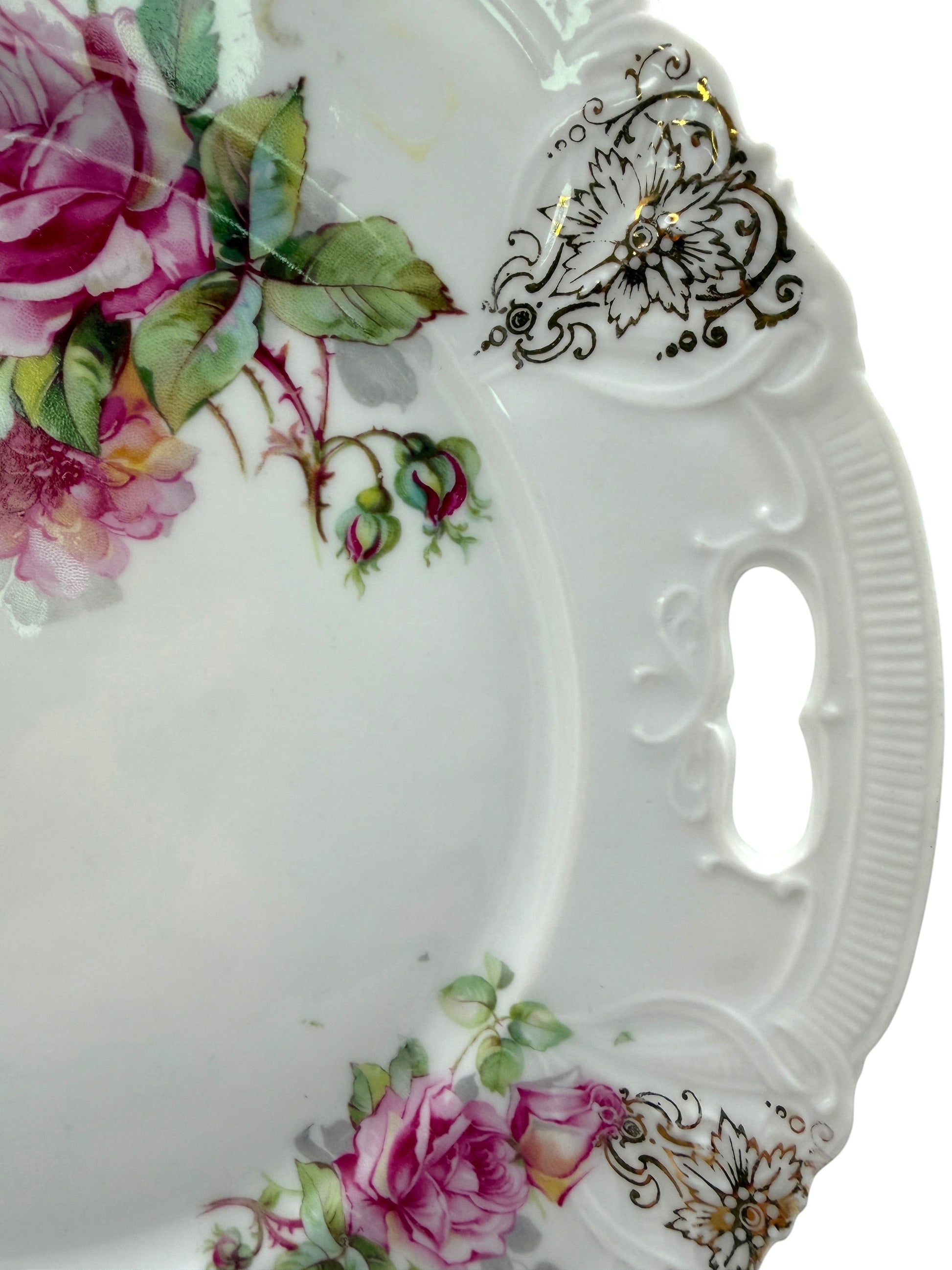 Hinson Vintage Interiors porcelain cake plate with pink roses, green leaves, and black-and-gold scrollwork details.