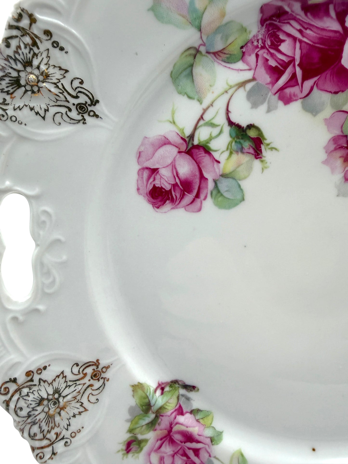 Hinson Vintage Interiors porcelain cake plate with pink roses, green leaves, and black and gold scroll accents.