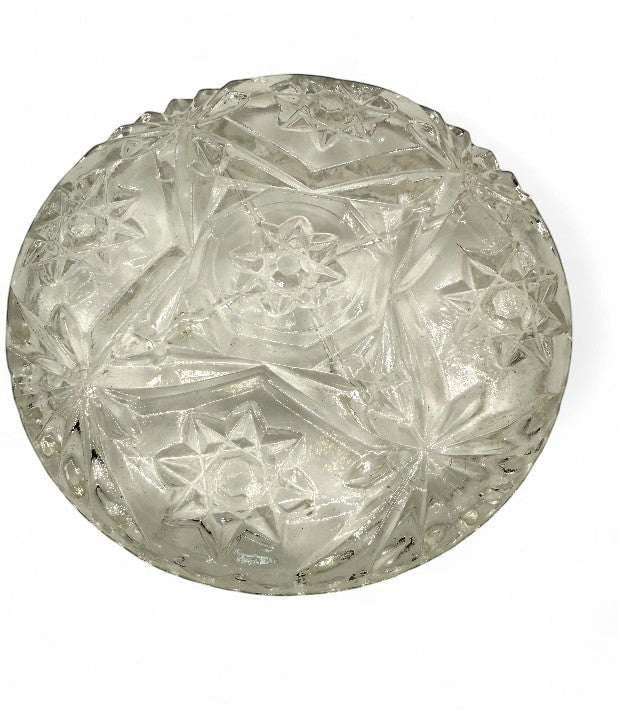 Hinson Vintage Interiors clear pressed glass coaster with a detailed starburst and floral pattern and scalloped edge