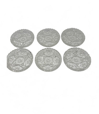 Hinson Vintage Interiors set of six clear pressed glass coasters with a vintage starburst and floral pattern.