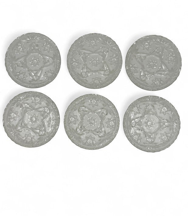Hinson Vintage Interiors set of six clear pressed glass coasters with a vintage starburst and floral pattern.
