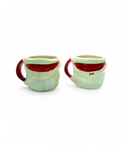 Hinson Vintage Interiors set of two hand-painted ceramic Santa Claus mugs with red handles from the 1950s.