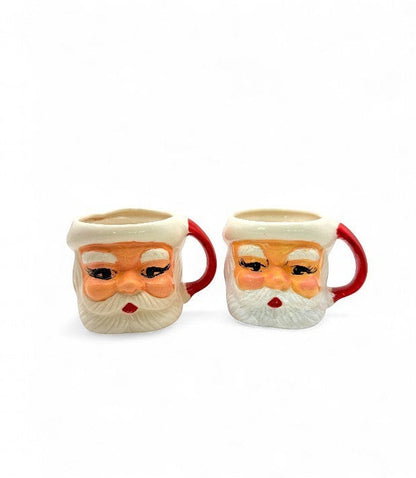 Hinson Vintage Interiors set of two hand-painted ceramic Santa Claus mugs with red handles from the 1950s.
